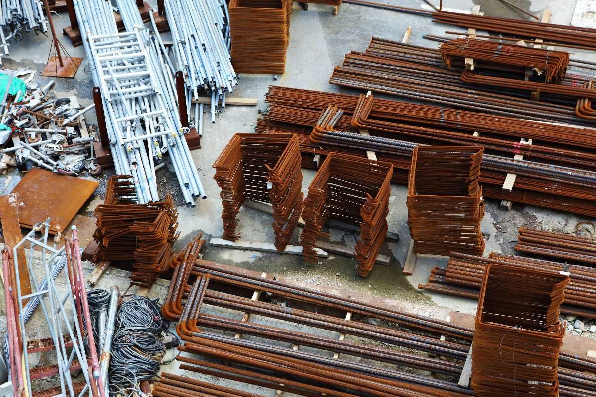 Steel reinforcement bars and scaffolding materials stored on a construction site