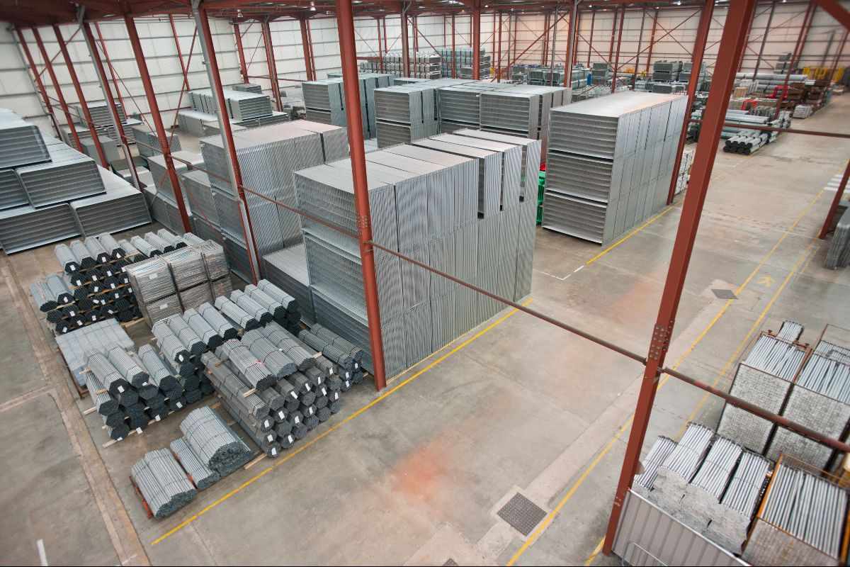 Organized steel materials stored in a warehouse to prevent corrosion and deformation