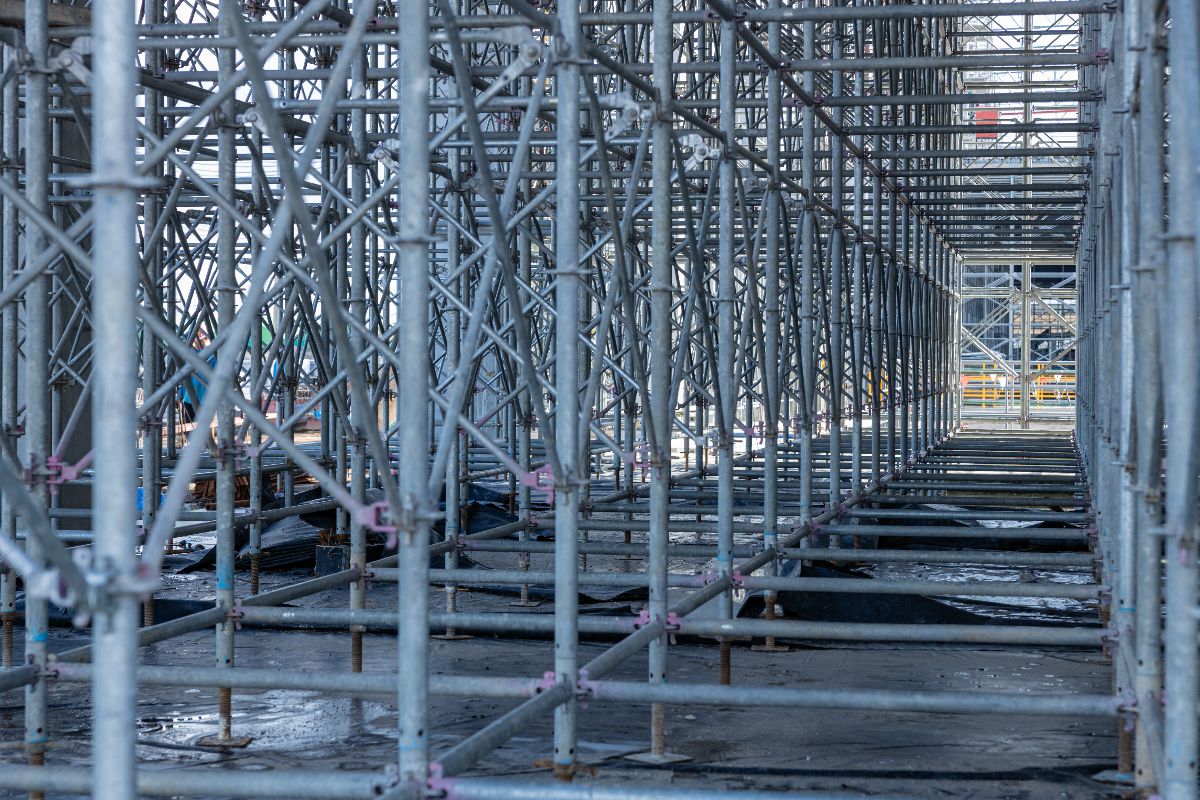 Steel scaffolding system organized on a busy construction site