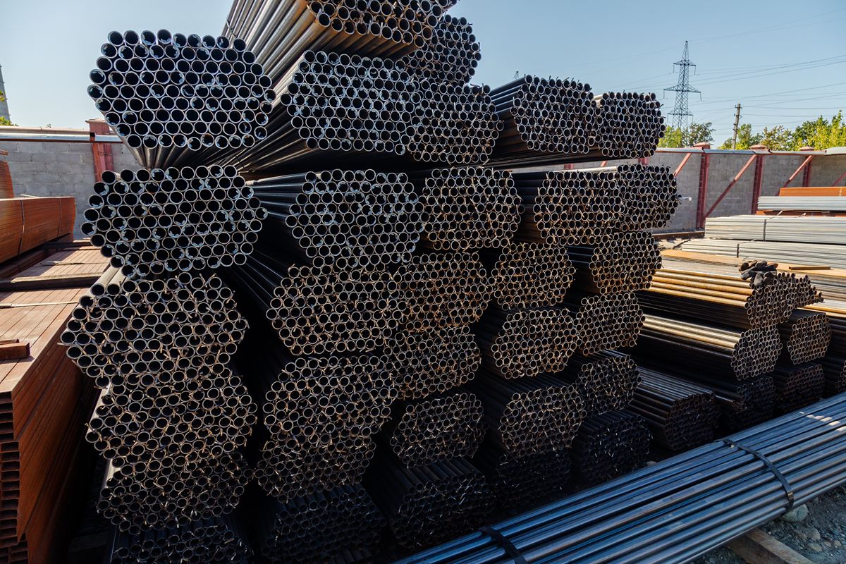 Bundles of high-grade steel pipes and structural materials representing construction efficiency, durability, and long-term project value